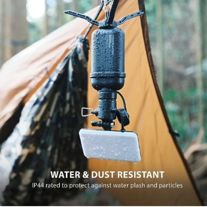 rugged flashlight accessory hanging upside down in the rain with tent in the background | WATER & DUST RESISTANT | IP44 rated to water splash and particles | NESTOUT durable outdoor accessories