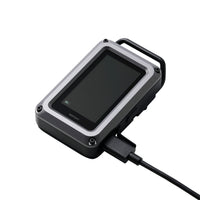 Black and gray CO monitor device with a USB cable connected on a white background