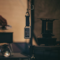 Digital CO monitor hanging on a stand with a blurred background