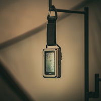 CO monitor on a strap hanging against a neutral background