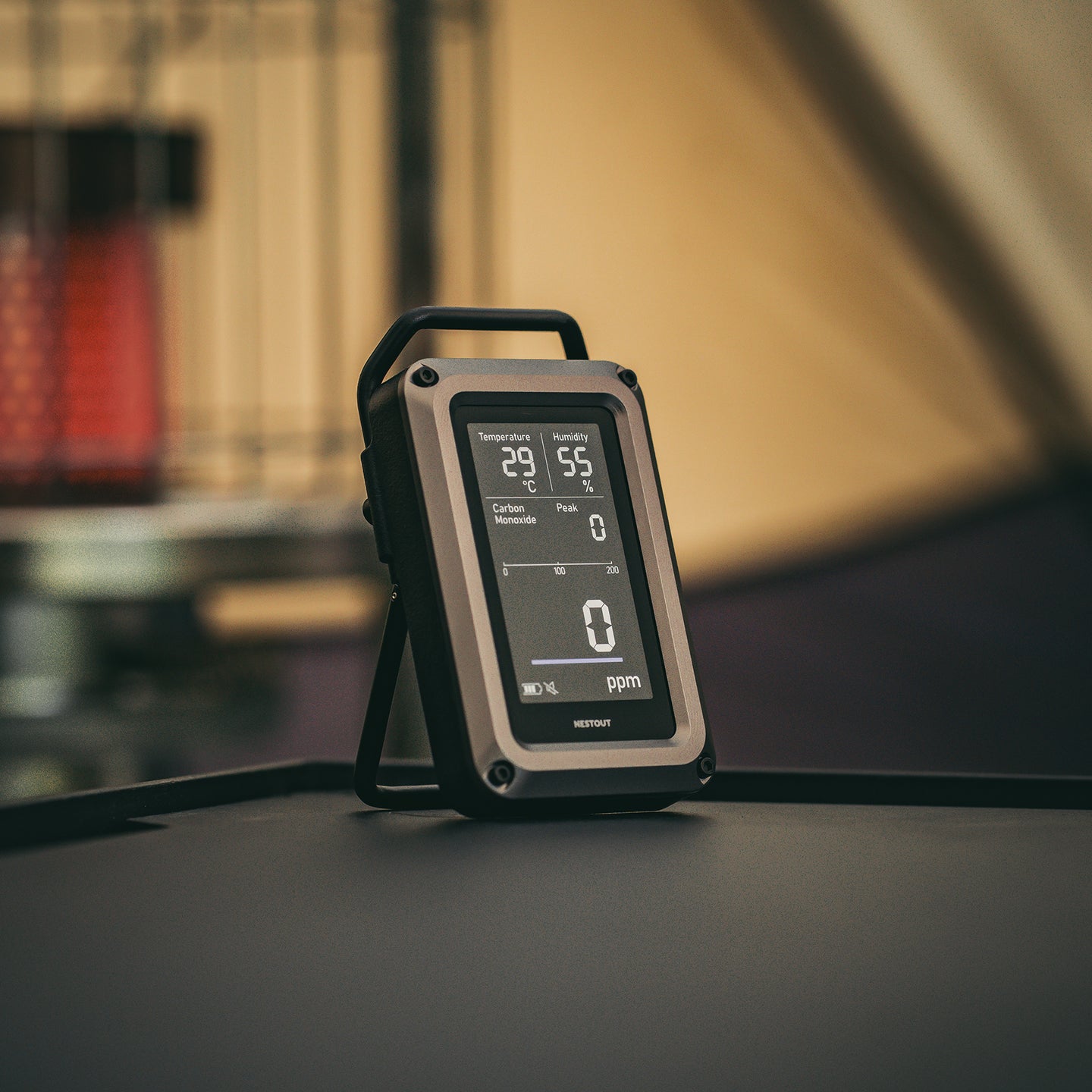 Digital CO monitor on a table with a blurred background