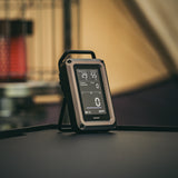 Digital CO monitor on a table with a blurred background