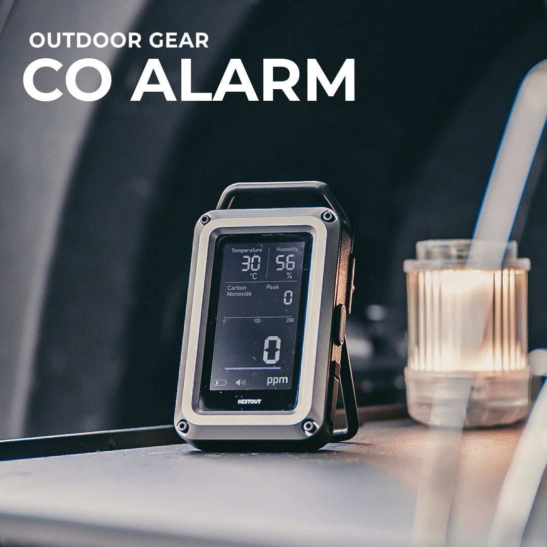 CO Alarm on a table with outdoor gear text above