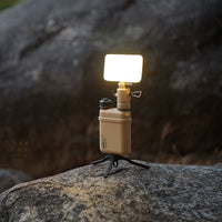 image of the nestout beige flash attached to the beige 15k nestout battery standing on tripod on a rock