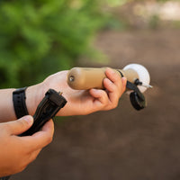 Image of hands showing the bottom screw thread of the nestout beige lamp where the tripod attaches