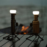 Image of nestout black lamp attached to 5k black battery and nestout beige lamp attached to beige 10k battery on tripods on a table