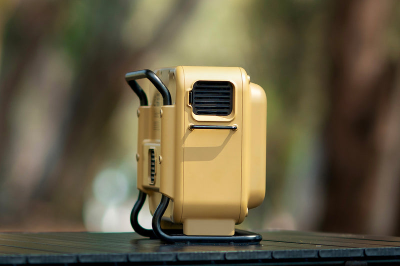 Portable power station lifted sideway, highlighting the dustproof cooling system for reliable outdoor performance.