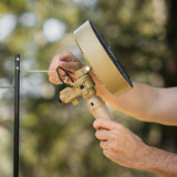 image of nestout beige fan with black tripod attached being hooked on