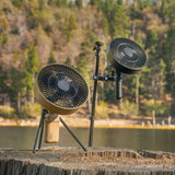 Image of nestout black and beige fan both with black tripod attached standing on a wood stump at jenks lake