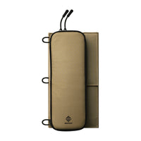 Folded up beige solar panel showcasing zippers and loops on a white background