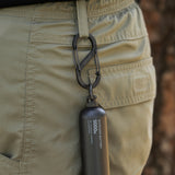black carabiner attached to a belt loop and it has a black 5k power bank attached.
