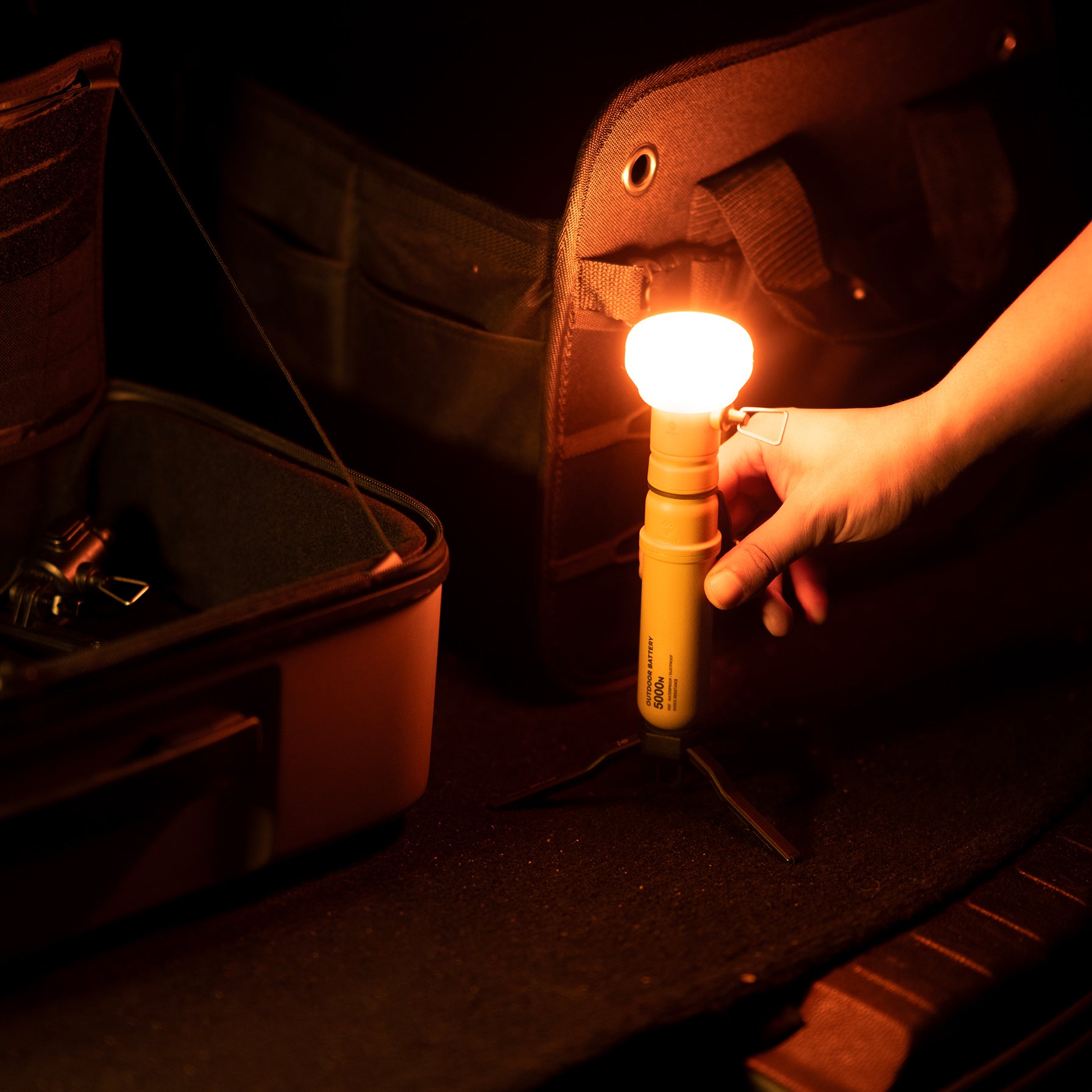 5k power bank with lamp attachment that has an orange filter on it