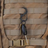 Black carabiner attached to a backpack and the carabiner has keys on them