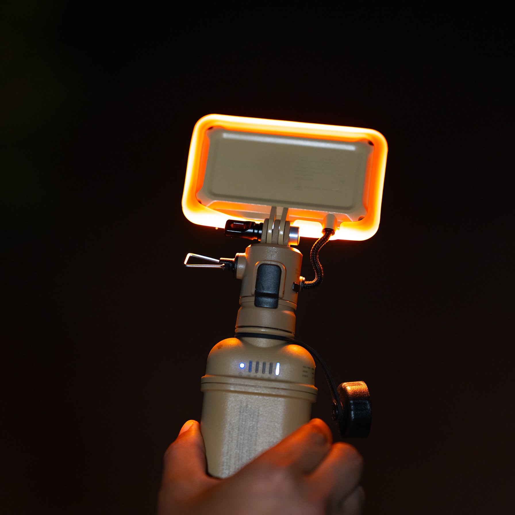 10k power bank with orange filter attached  to a flash-1 light