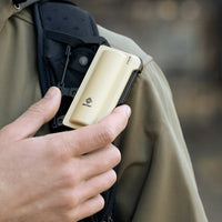 image of the nestout beige 5000n carabiner battery attached to backpack strap