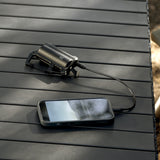 image of the nestout black 5000n carabiner battery charging smartphone on a table