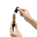 image of hands unscrewing the mouthpiece of the nestout beige whistle light which shows where the AAA battery goes into