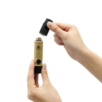 image of hands unscrewing the mouthpiece of the nestout beige whistle light which shows where the AAA battery goes into