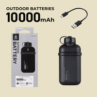 Black outdoor power bank with packaging and USB cable on a beige background