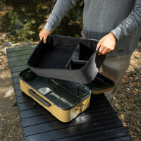 large beige gear case featuring a person holding the inner lining foam divider