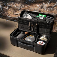 Black gear case with various compartments on a table outdoors