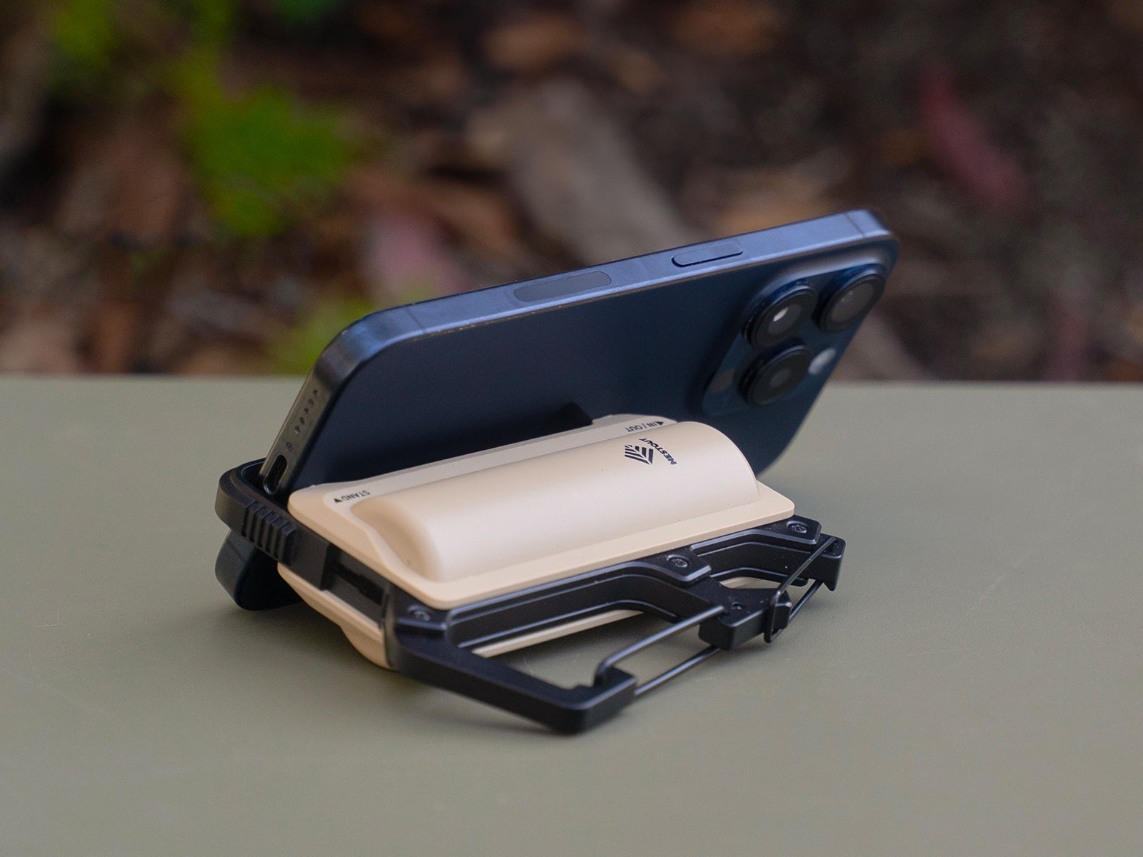 5000 mah beige carabiner power bank holding a phone