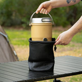 Beige outdoor cooker being taking out of provided black bag