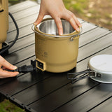 Beige Outdoor Cooker being plugged into a power station outside. 