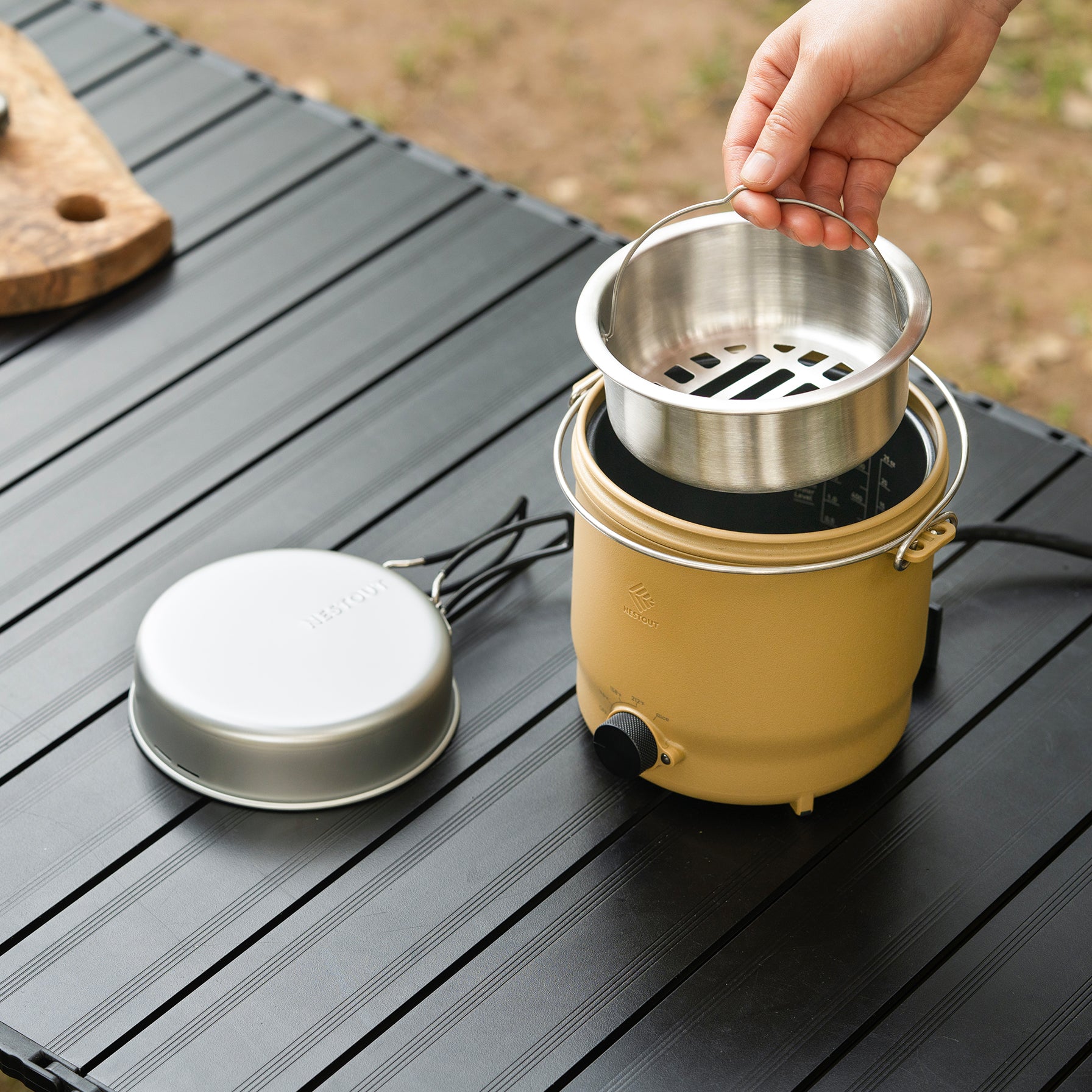 Outdoor cooker showing its inside metal compartment components outside