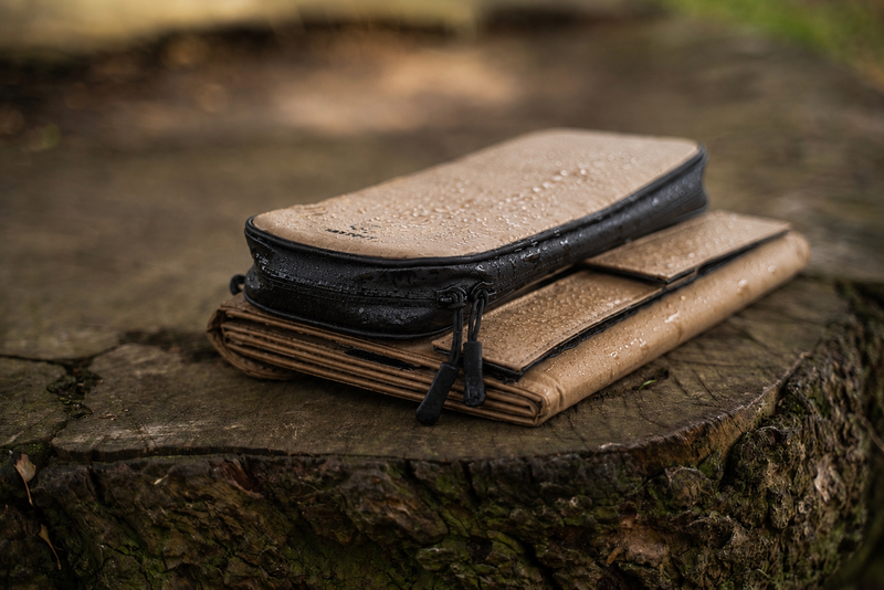 Folded solar charger with light mist on it on  top of a tree stump