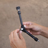 Hands adjusting the knob on the black arm
