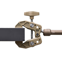 Beige clamp arm clamped onto a desk with a white background 