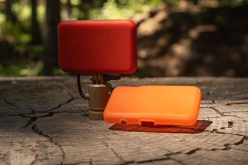 Red filter attached to flash-1 led light and orange filter that is on the ground outdoors