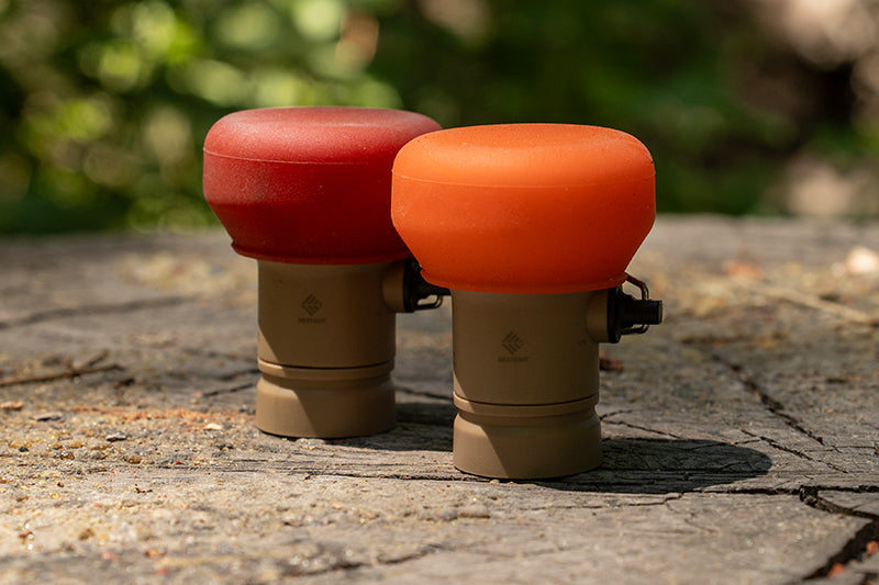 two portable lantern light attachments with a red and orange filter attached to the lights