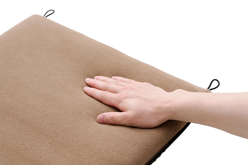 beige pad-1 heater blanket being felt by a hand