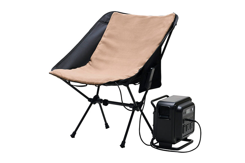 Beige pad on a outdoor char plugged into a black nestout power station