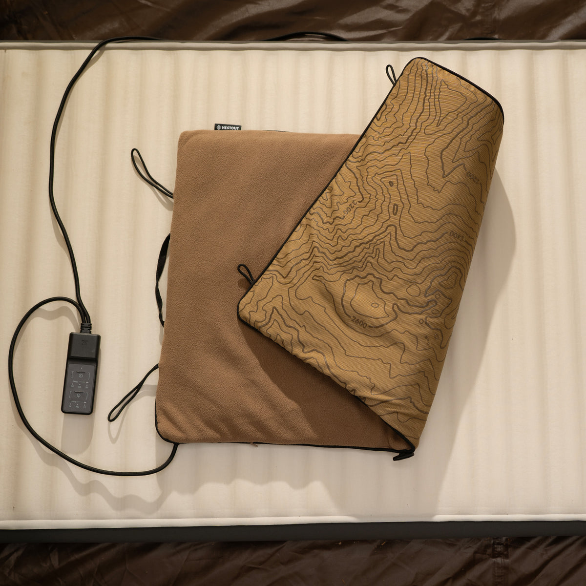 Beige pad-1 heater pad on a mattress showing the power controller next to it