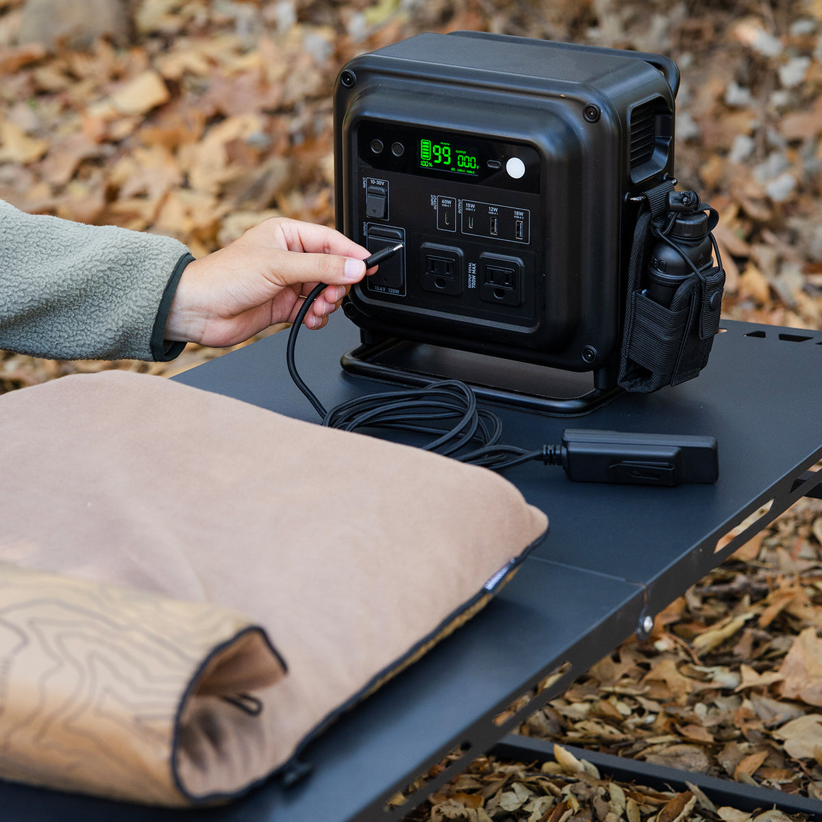 Black Power station powering the the PAD-1 Heater pad outdoors 