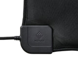 A close-up of the heating pad's corner cable connector with an embossed NESTOUT logo, attached to the black heating unit and shown on a white background.