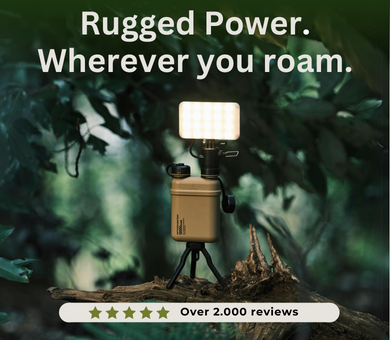 Rugged Power. Wherever you roam. Over 2,000 reviews | outdoor greenery image of NESTOUT products with beige battery, mini tripod, and flashlight attachment | solar powered outdoor accessories