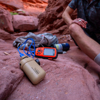 NESTOUT beige 10000mAh power bank connected to device in the Arizona cliffs 