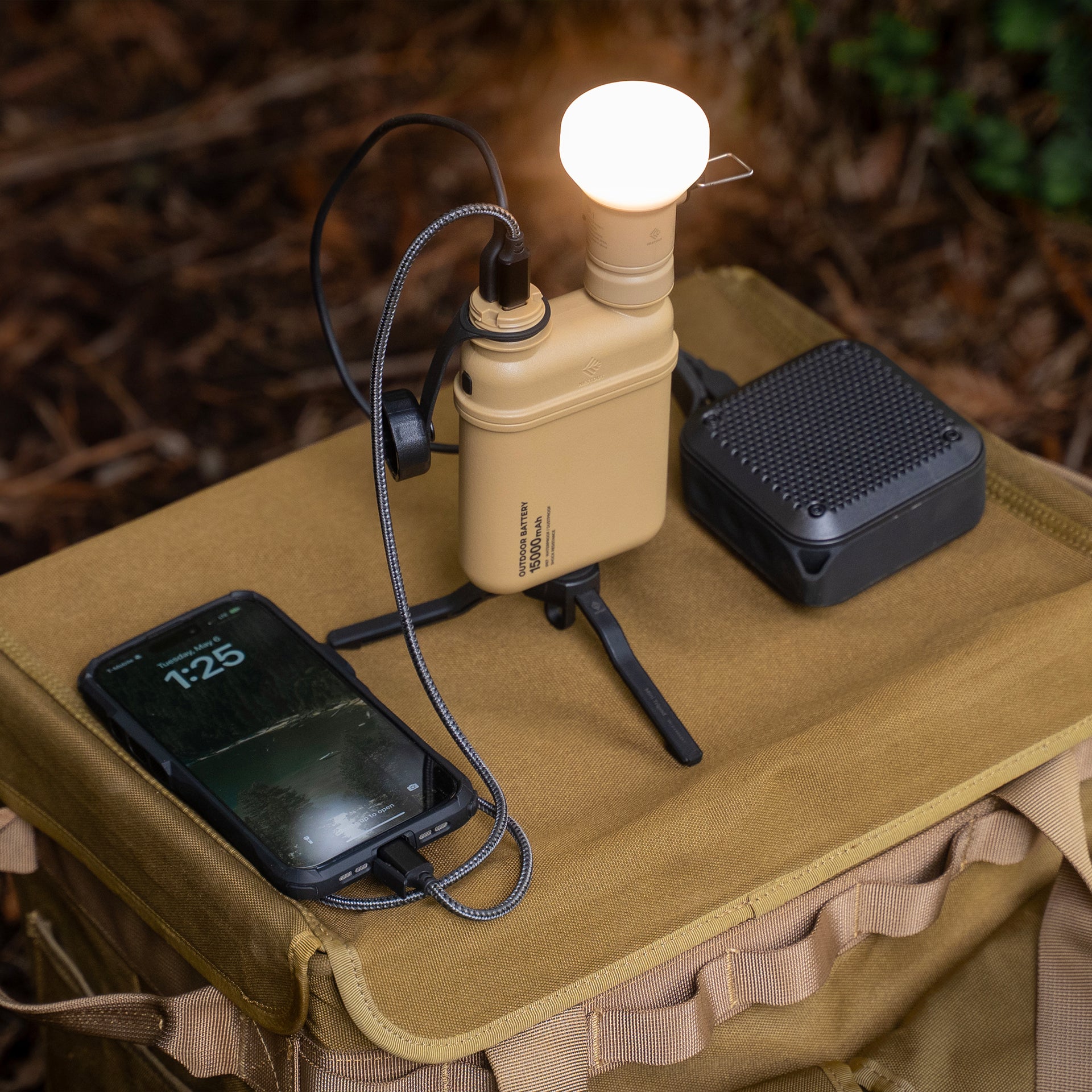 150000mAh battery pack on a stand connected to NESTOUT lamp attachment, speaker, and smartphone 