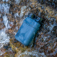 Image of wet nestout 15k grey colored cylinder battery pack with military IP67 rating | stores up to 15000N of power | rugged waterproof design | compact size | versatile charging | to be used with NESTOUT solar panels, fans, lamps, and flashes
