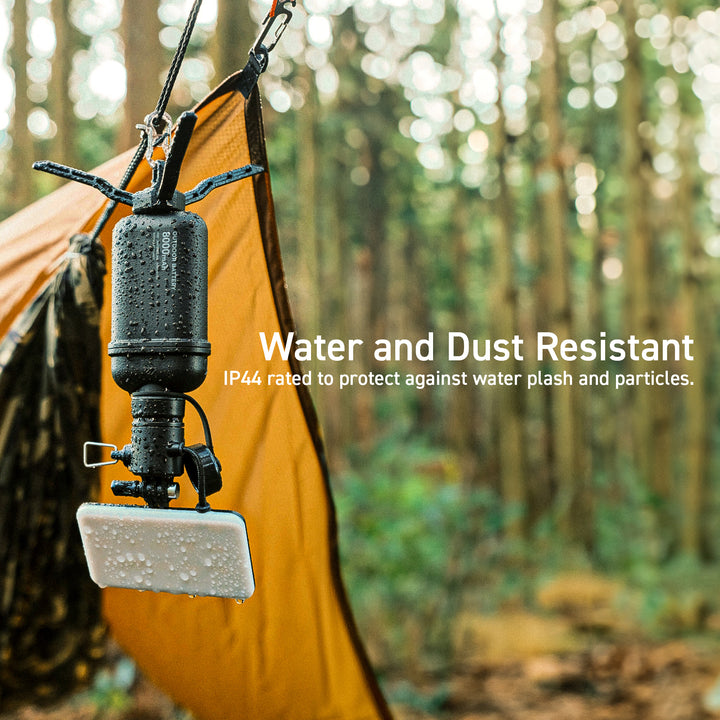 rugged flashlight accessory hanging upside down in the rain with tent in the background | WATER & DUST RESISTANT | IP44 rated to water splash and particles | NESTOUT durable outdoor accessories